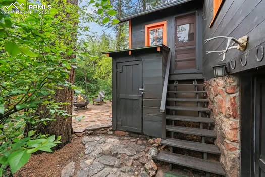 6015 Sioux Trail Cascade, CO 80809 - Photo 29 of 42 a view of a house with a door and wooden walls