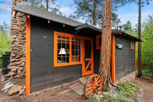 6015 Sioux Trail Cascade, CO 80809 - Photo 3 of 42 a front view of a house with a yard