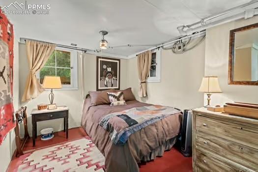 6015 Sioux Trail Cascade, CO 80809 - Photo 31 of 42 a bed room with a bed and a lamp