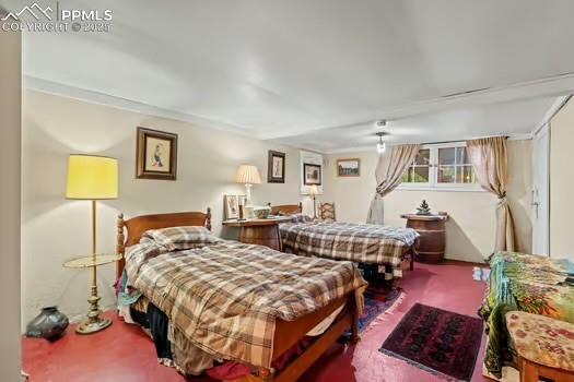 6015 Sioux Trail Cascade, CO 80809 - Photo 33 of 42 a bedroom with bed and a lamp