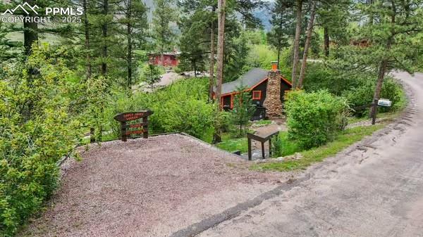 6015 Sioux Trail Cascade, CO 80809 - Photo 40 of 42 a view of a garden with large trees