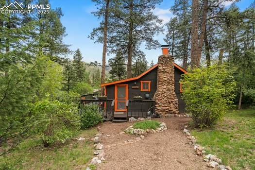6015 Sioux Trail Cascade, CO 80809 - Photo 42 of 42 a view of a house with a tree in the yard