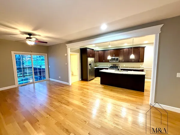 a view of kitchen and kitchen with furniture wooden floor and window