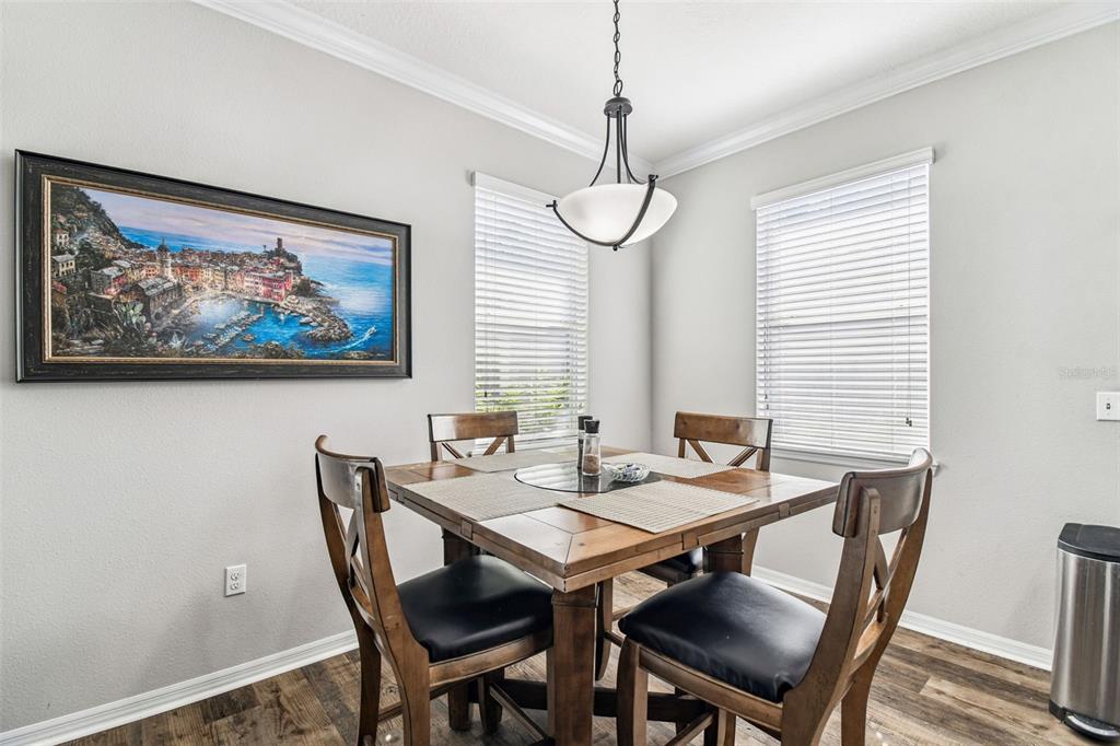 11150 Paradise Pointe Way New Port Richey, FL 34654 - Photo 11 of 91 a view of a dining room with a table and chairs
