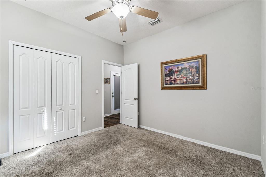 11150 Paradise Pointe Way New Port Richey, FL 34654 - Photo 21 of 91 a view of a livingroom with an empty space and a ceiling fan