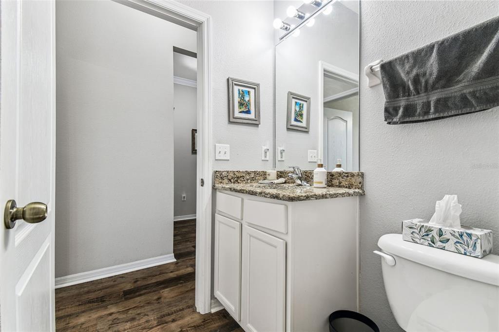 11150 Paradise Pointe Way New Port Richey, FL 34654 - Photo 23 of 91 a bathroom with a granite countertop sink and a mirror