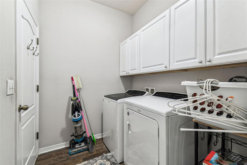 11150 Paradise Pointe Way New Port Richey, FL 34654 - Photo 27 of 91 a view of a storage and utility room with washer and dryer