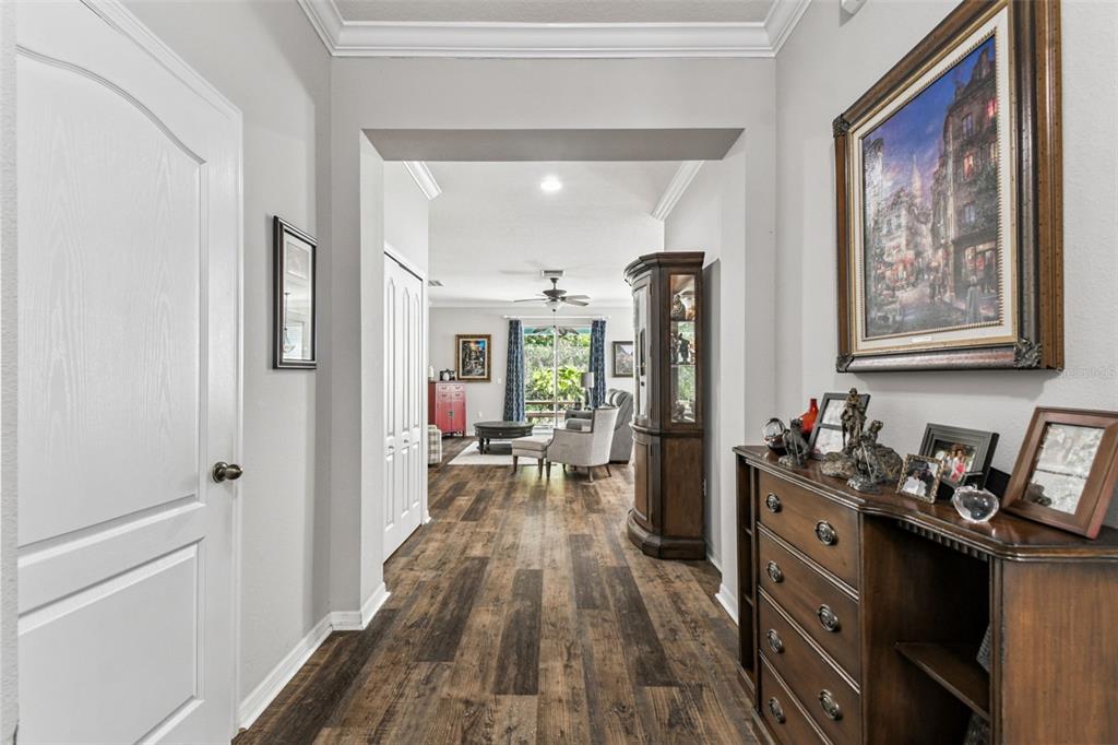 11150 Paradise Pointe Way New Port Richey, FL 34654 - Photo 6 of 91 a view of a hallway with wooden floor and furniture