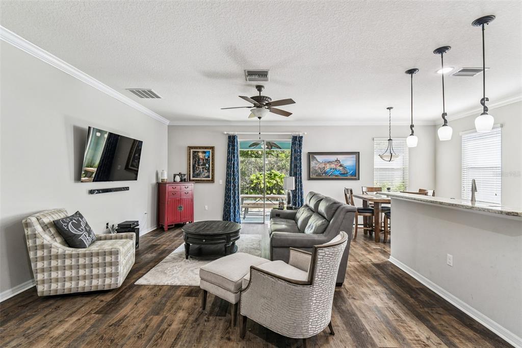 11150 Paradise Pointe Way New Port Richey, FL 34654 - Photo 9 of 91 a living room with furniture a flat screen tv and a large window