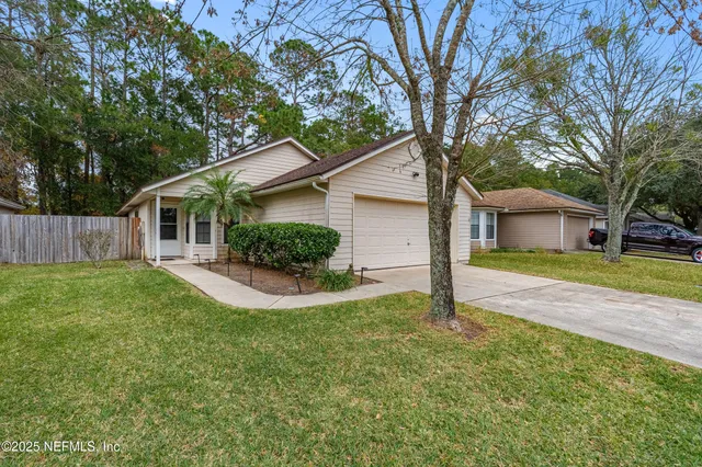 a front view of house with yard and green space