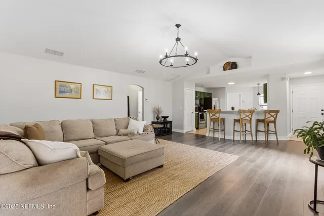 a living room with furniture kitchen view and a dining table