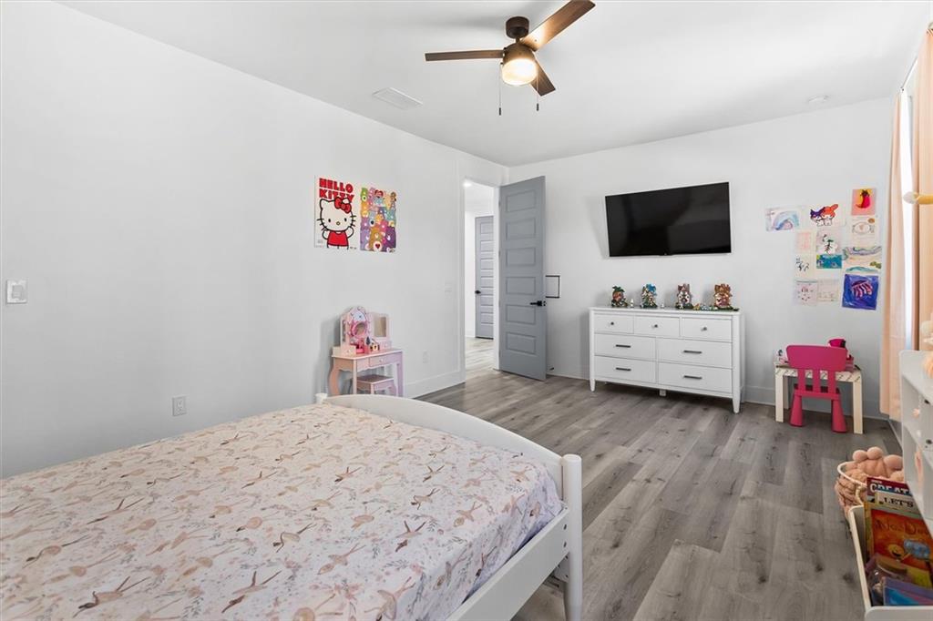658 Rockbridge Road Northwest Lilburn, GA 30047 - Photo 22 of 61 a bedroom with a bed and a flat screen tv