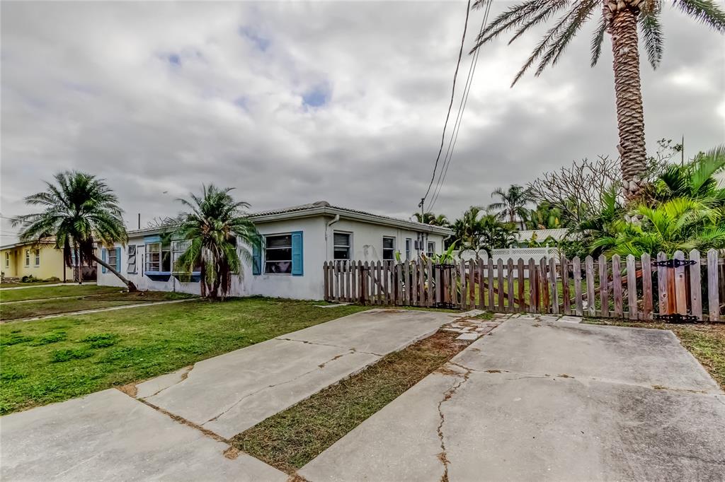 245 145th Avenue Madeira Beach, FL 33708 - Photo 13 of 41 a front view of house with a garden