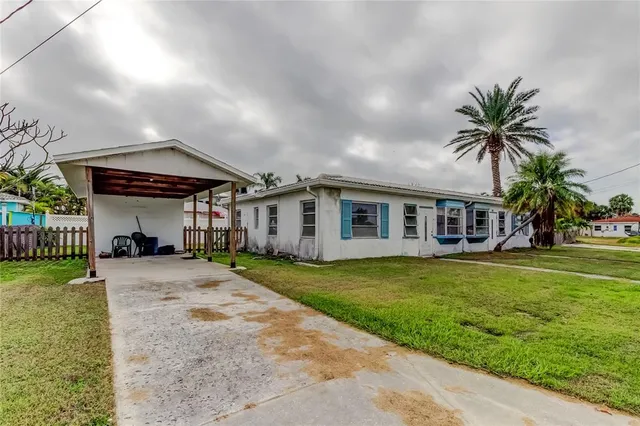 a view of a house with backyard and couches