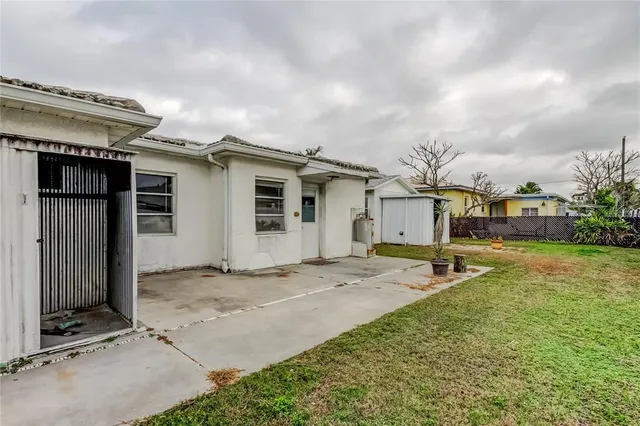 a view of patio with table and chairs and potted plants with wooden fence