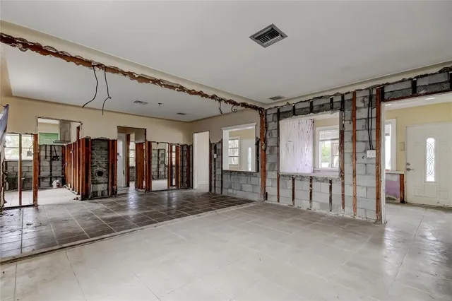 a view of a hallway with furniture and a window