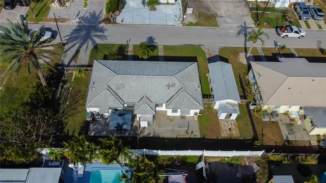 an aerial view of a house with a yard