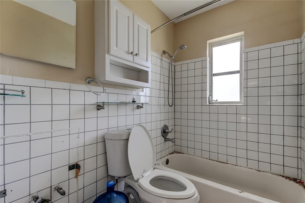 245 145th Avenue Madeira Beach, FL 33708 - Photo 35 of 37 a bathroom with a sink a toilet and bathtub