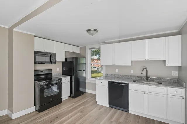 a kitchen with appliances cabinets and a sink
