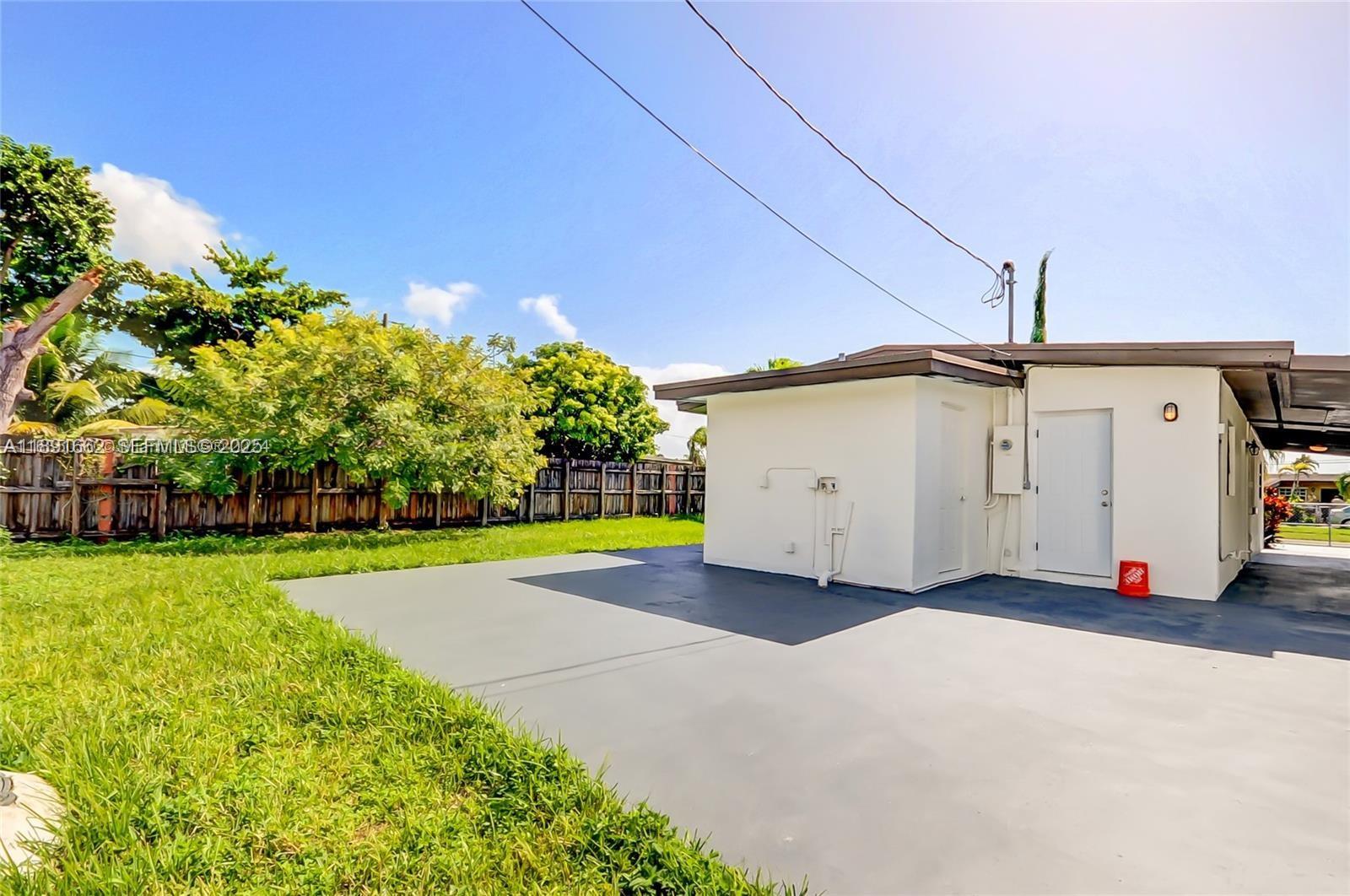 14465 Southwest 290th Terrace Homestead, FL 33033 - Photo 16 of 31 a view of a white house with a yard