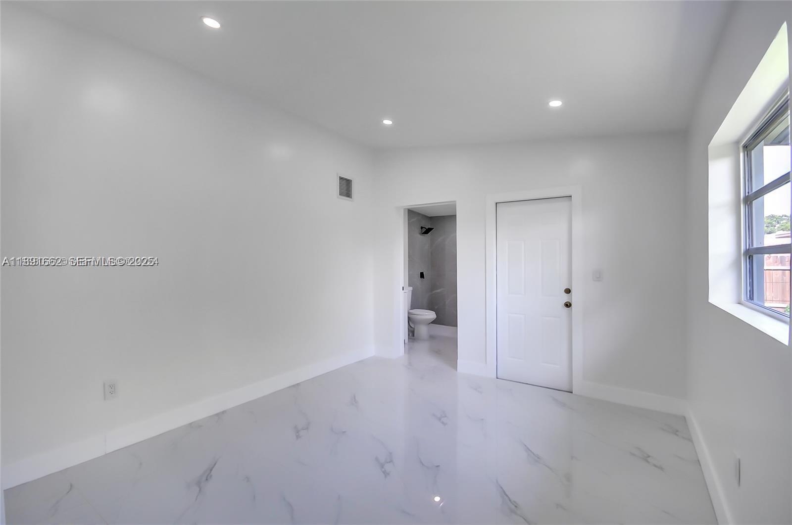 14465 Southwest 290th Terrace Homestead, FL 33033 - Photo 18 of 31 a view of an empty room with a window