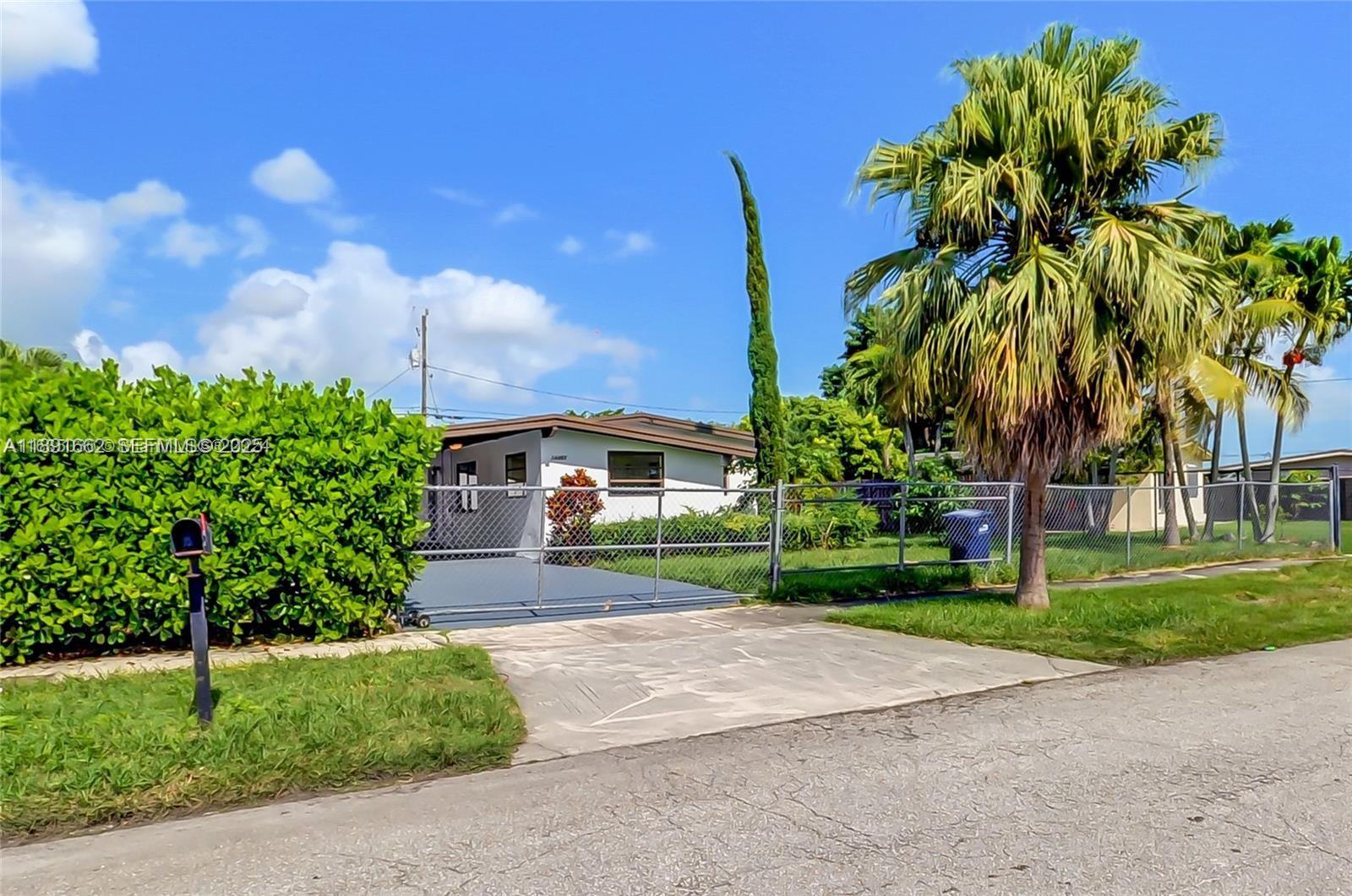 14465 Southwest 290th Terrace Homestead, FL 33033 - Photo 23 of 31 a front view of a house with garden