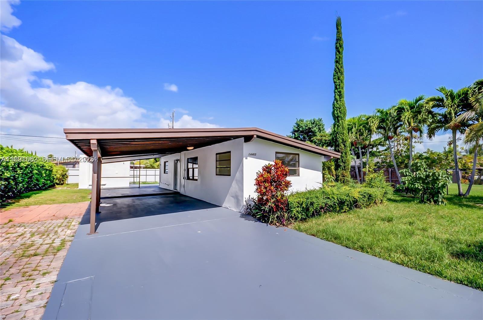 14465 Southwest 290th Terrace Homestead, FL 33033 - Photo 27 of 31 a front view of a house with garden