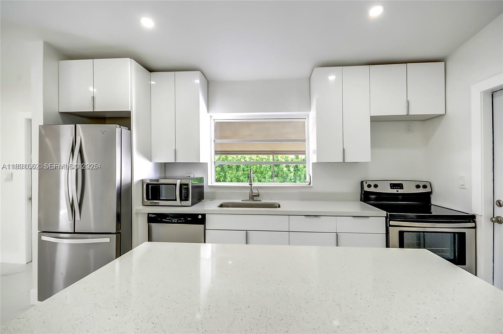 14465 Southwest 290th Terrace Homestead, FL 33033 - Photo 3 of 31 a kitchen with stainless steel appliances a refrigerator sink and stove