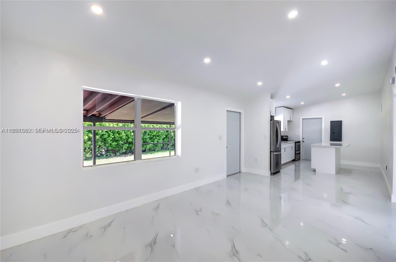 14465 Southwest 290th Terrace Homestead, FL 33033 - Photo 6 of 31 a view of an empty room with a window