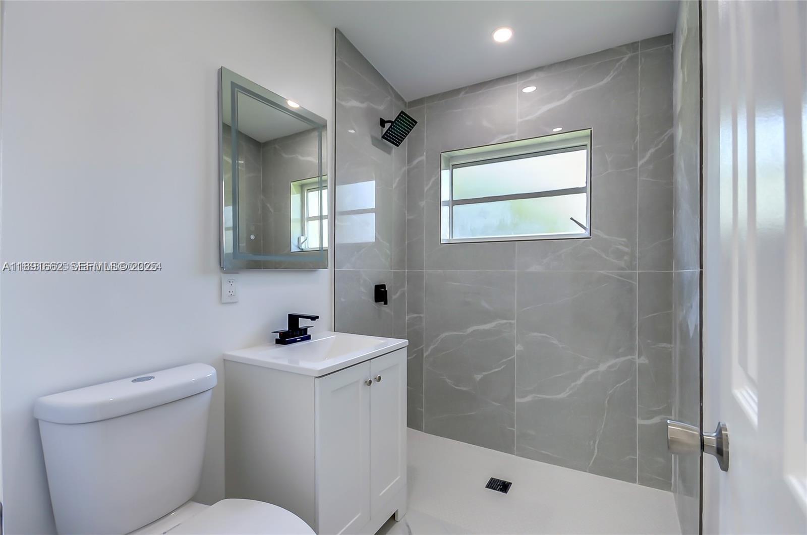 14465 Southwest 290th Terrace Homestead, FL 33033 - Photo 8 of 31 a bathroom with a sink mirror toilet and shower