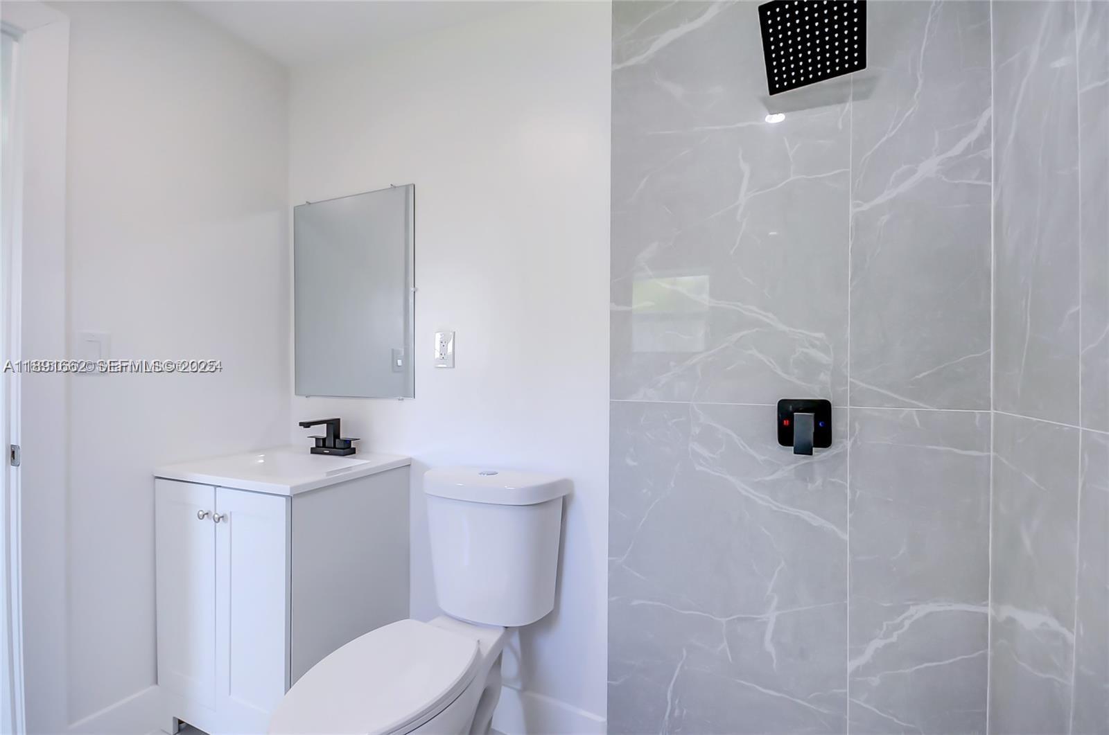 14465 Southwest 290th Terrace Homestead, FL 33033 - Photo 10 of 31 a white toilet sitting next to a bathroom sink