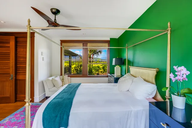 a bedroom with a bed and a potted plant