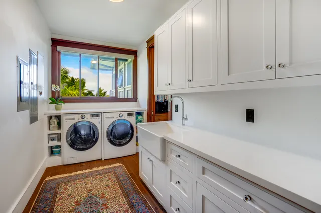 a utility room with sink dryer and washer
