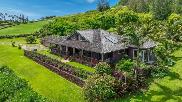 an aerial view of house with yard and outdoor seating