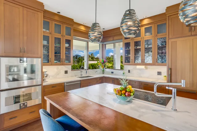 a view of a kitchen with a large window and stainless steel appliances