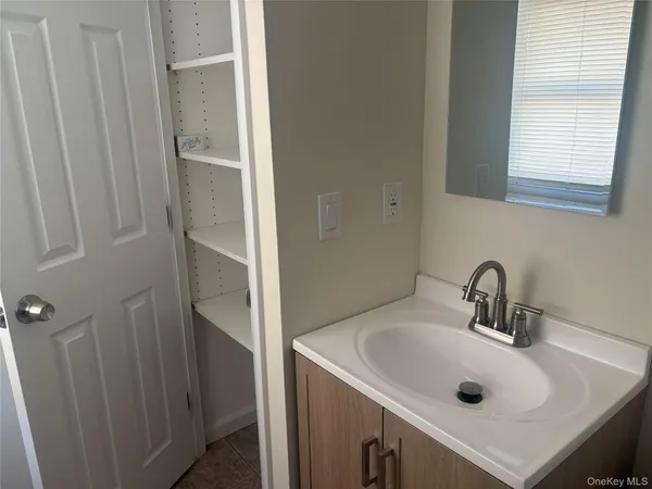 a bathroom with a sink and a window