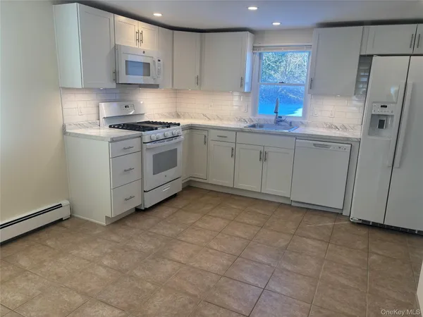 a kitchen with cabinets and window