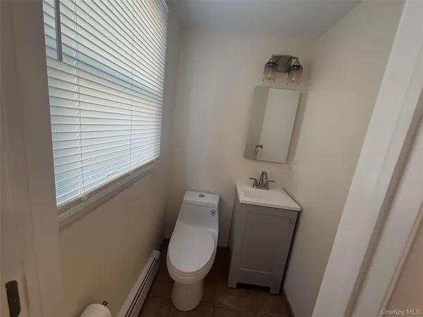 a white toilet sitting next to a sink