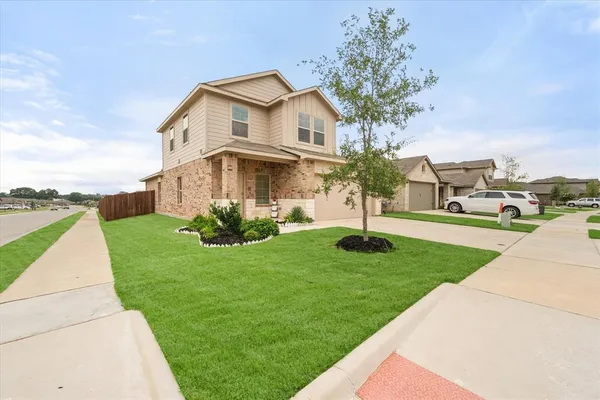 a view of a house with a yard and sitting area