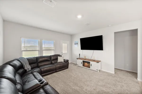 a kitchen with stainless steel appliances a table and chairs