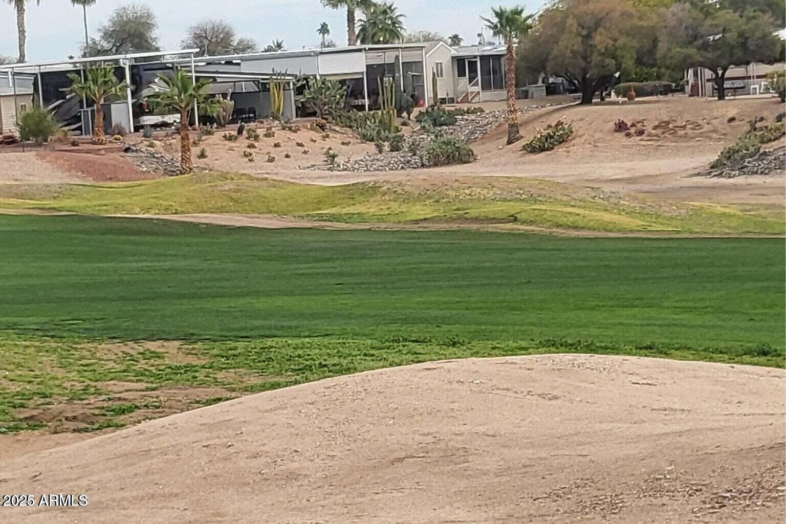 17200 West Bell Road, Unit 712 Surprise, AZ 85374 - Photo 13 of 19 a view of a swimming pool with a lawn chairs and a small yard