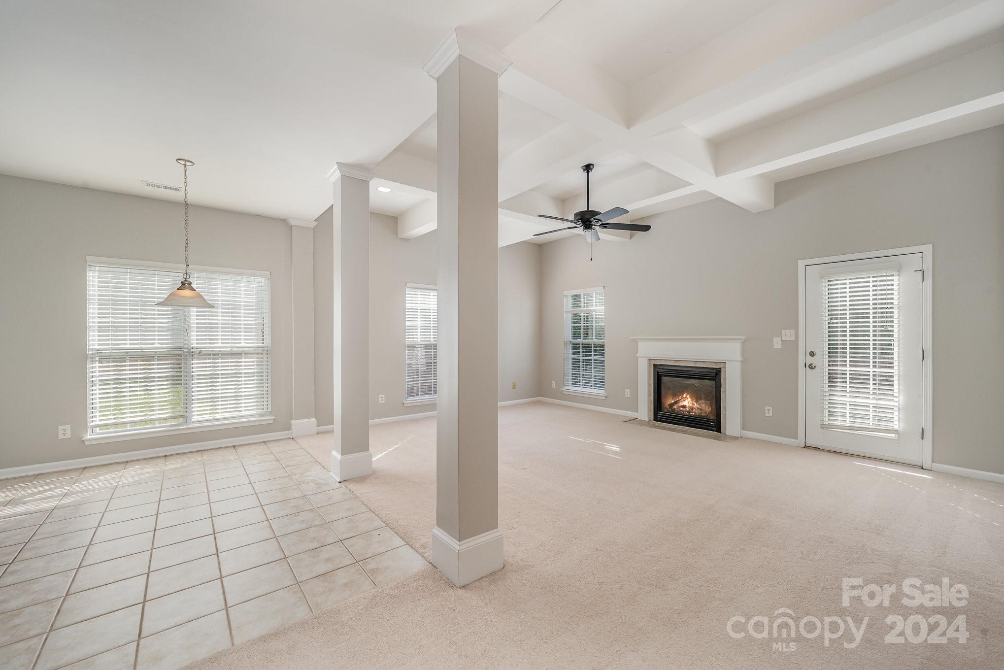 13341 Meadowmere Road Huntersville, NC 28078 - Photo 3 of 22 a view of an empty room with a fireplace and a window