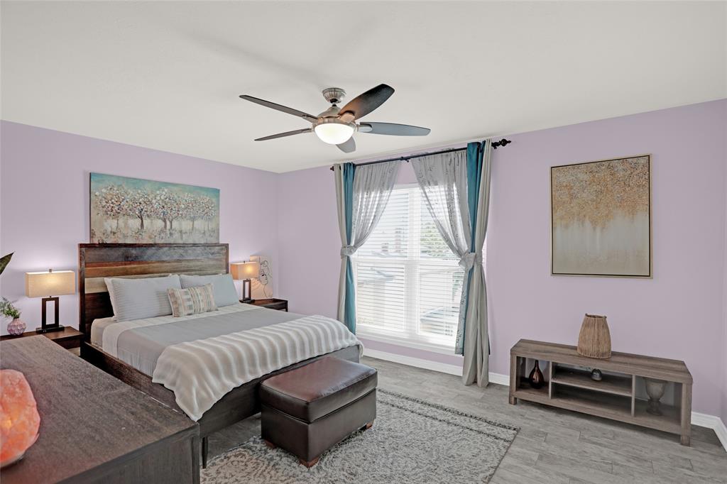 12834 Midway Road, Unit 2110 Dallas, TX 75244 - Photo 12 of 22 Bedroom featuring wood finished floors and ceiling fan