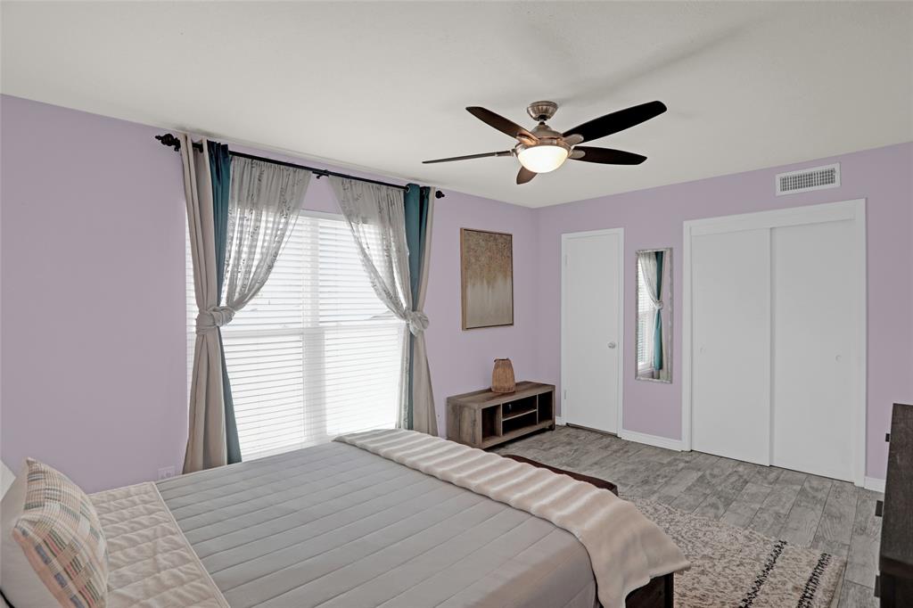 12834 Midway Road, Unit 2110 Dallas, TX 75244 - Photo 13 of 22 Bedroom with light wood-style floors, a closet, and a ceiling fan