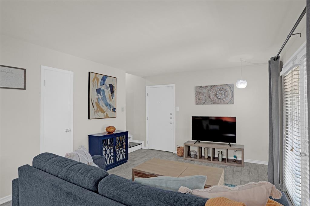 12834 Midway Road, Unit 2110 Dallas, TX 75244 - Photo 2 of 22 Living room featuring light wood-type flooring and baseboards