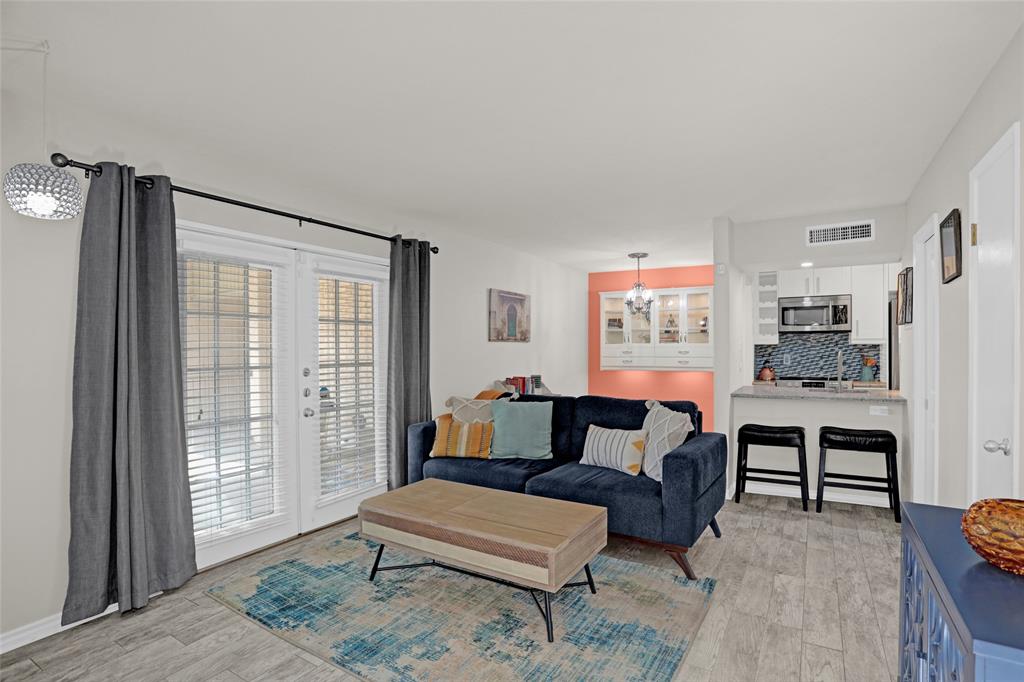 12834 Midway Road, Unit 2110 Dallas, TX 75244 - Photo 3 of 22 Living room with suspended lighting, light wood-style flooring, and french doors