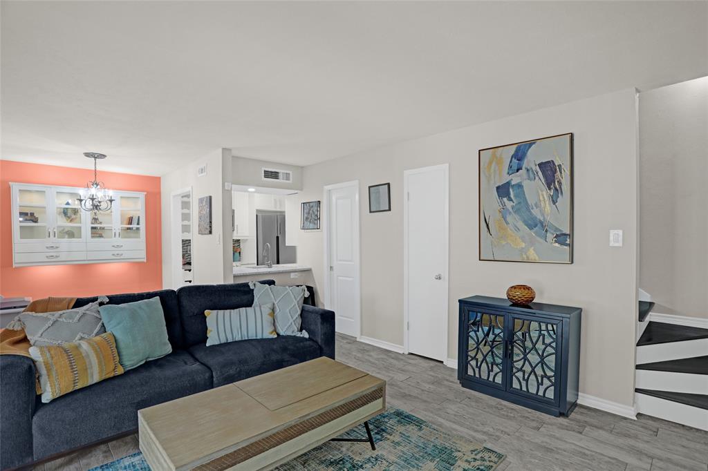 12834 Midway Road, Unit 2110 Dallas, TX 75244 - Photo 4 of 22 Living room with hanging lights and light wood-style flooring