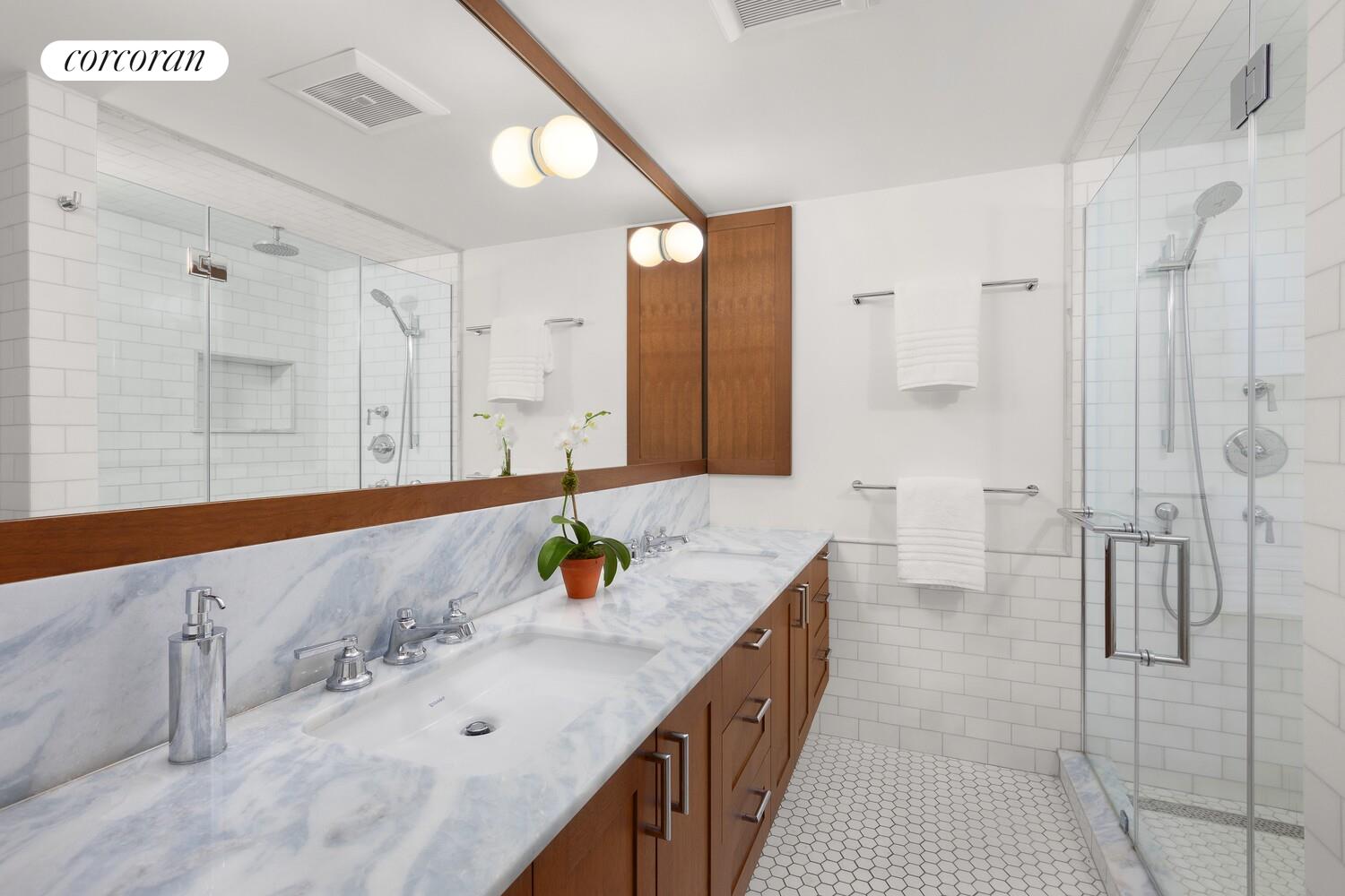 21 Bethune Street, Unit GARDEN Manhattan, NY 10014 - Photo 4 of 8 a bathroom with a granite countertop sink and a mirror