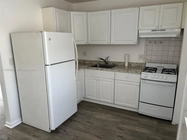 a white refrigerator freezer sitting inside of a kitchen