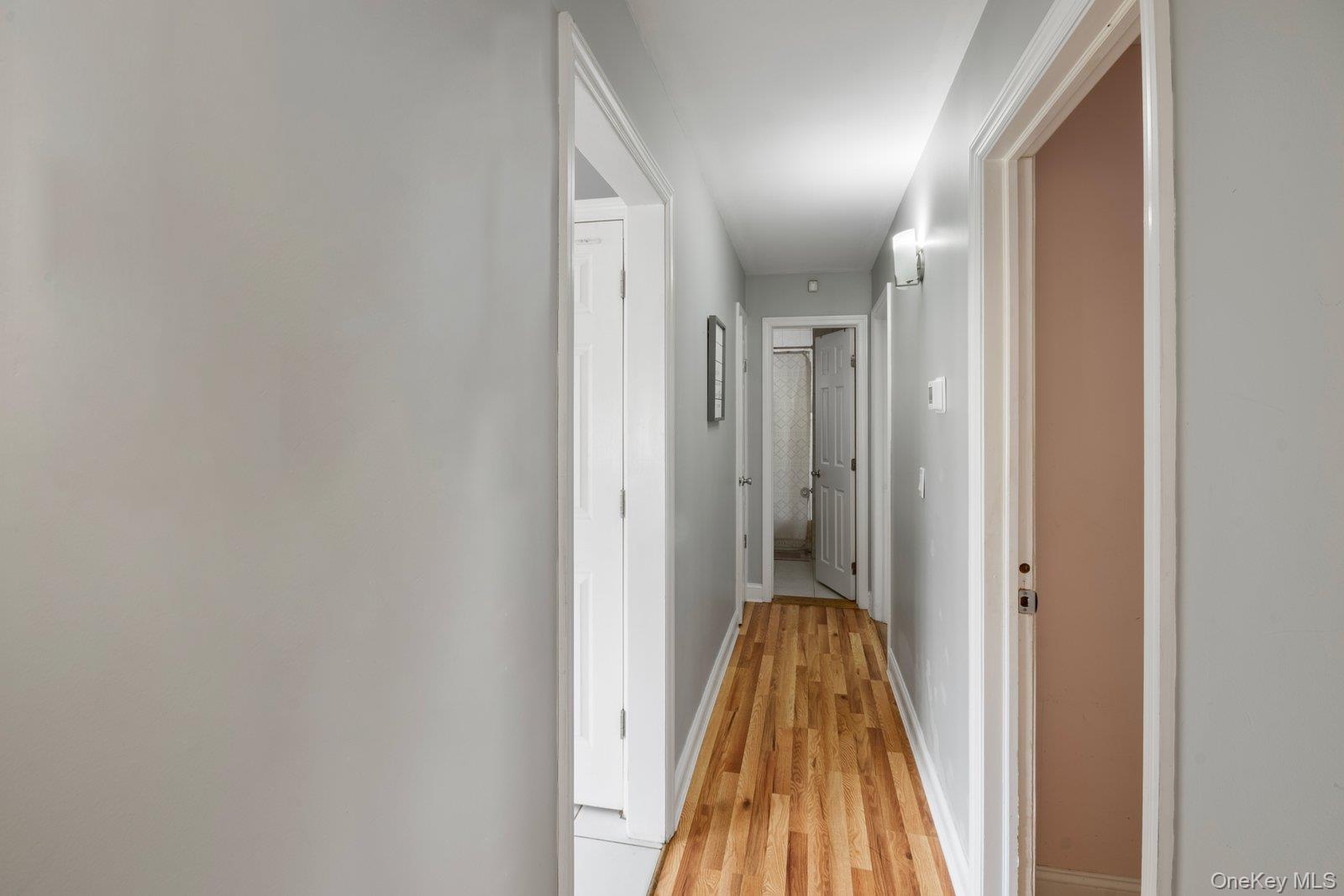 277 Horseblock Road Farmingville, NY 11738 - Photo 11 of 28 Corridor featuring baseboards and light wood finished floors